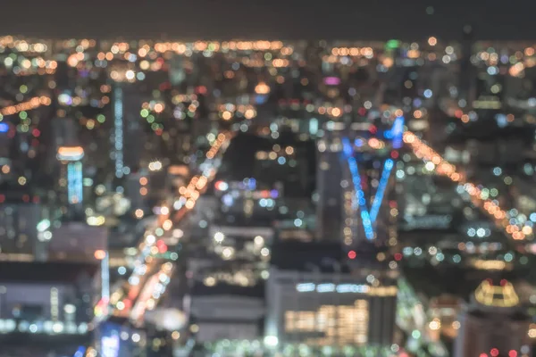 Blur city background rooftop view of Bangkok cityscape business building landscape night lights bokeh