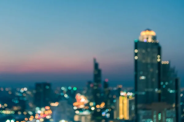 Blur city background rooftop view of cityscape business building landscape night lights bokeh