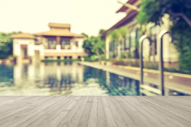 Ahşap zemin yazın arka planı bulanık otel havuzunda mavi yüzme havuzu suyu