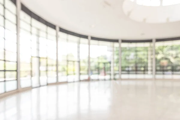 Blur background interior view looking out toward to empty office lobby and entrance doors and glass curtain wall