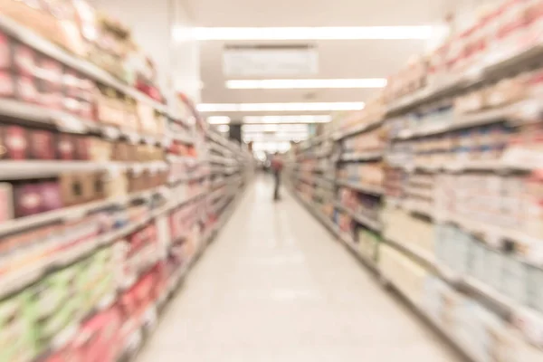 Blurred supermarket background indoor grocery store with shelves food products and diary supplies for shopping