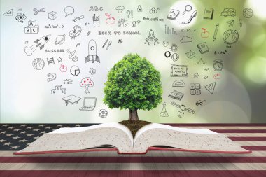 Tree of knowledge and life growing from big archive open textbook with doodle on USA flag pattern on wood table: Read across america day concept clipart