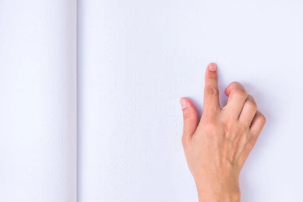 Braille book with visual impaired, low vision, blind person's hand/ finger touching paper texture reading the sign