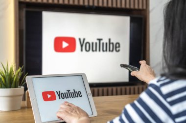 Bangkok, Tayland, 25 Şubat 2021: Youtube logosu, video içerikli sosyal medya uygulaması İPad ve TV ekranı paylaşımı