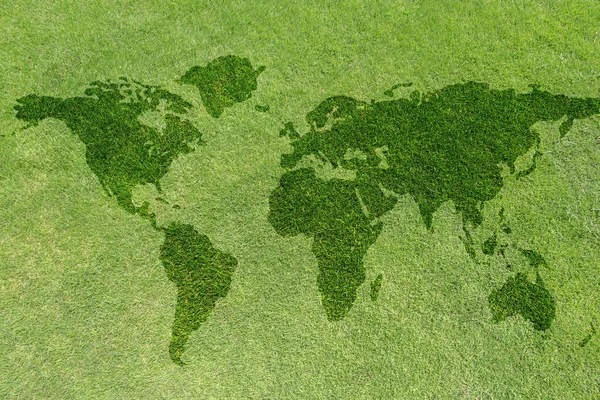 World map on green grass lawn background for global eco-friendly environment, ecological and environmental saving, earth day, and go green backdrop concept