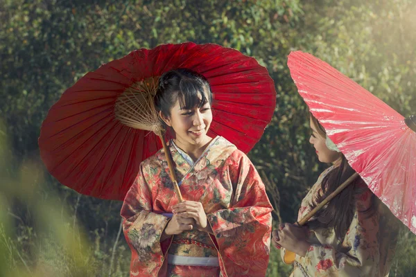 Girls in kimonos acting smile — Stock Photo, Image