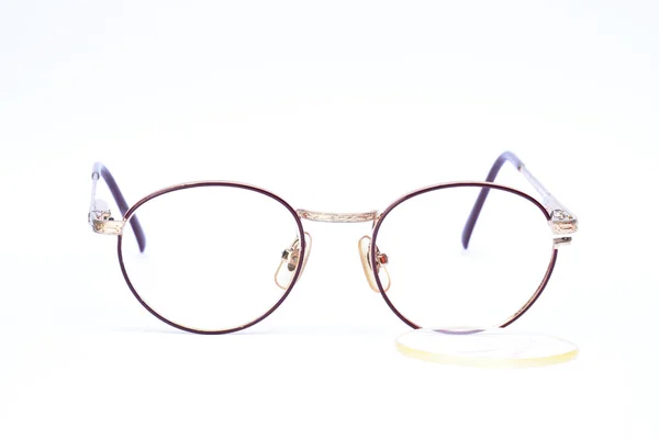 Eyeglasses fall from frame on white background — Stock Photo, Image