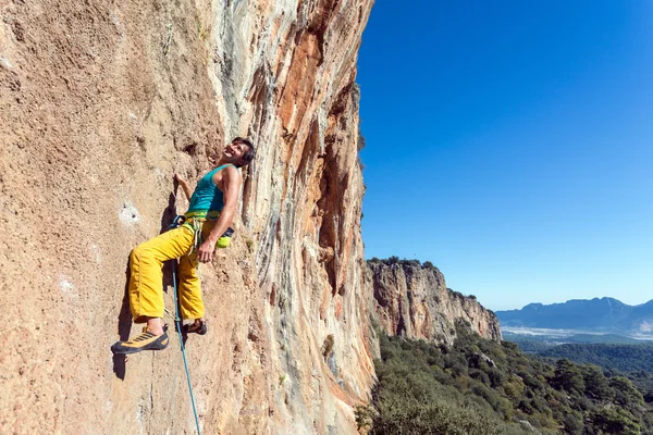 Ler mogna manlig extrema klättrare hängande på rocky vägg lätt — Stockfoto