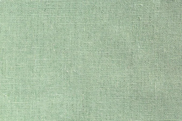 Blek grön tyg bakgrund med tydlig Canvas konsistens — Stockfoto