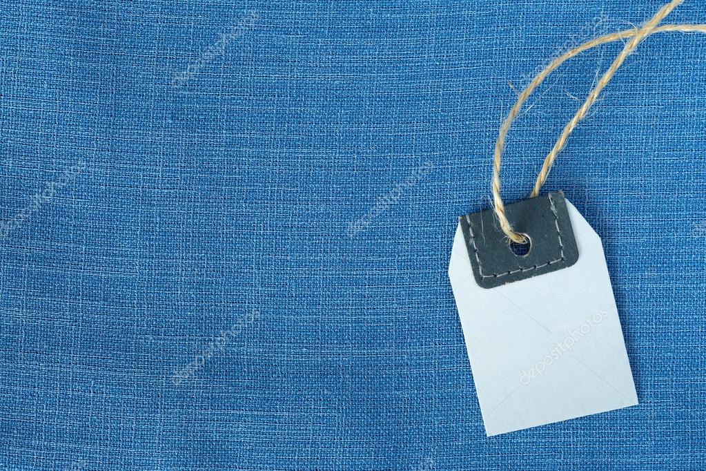 Light blue Fabric Background and blank Price Tag Stock Photo by