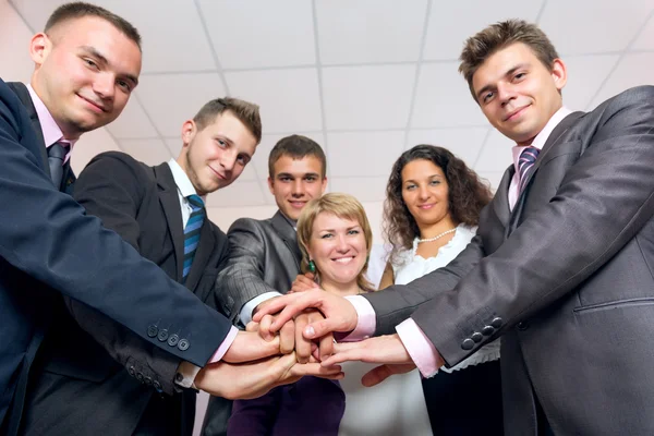 Happy Business Team uniting Hands and smiling Stock Image