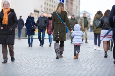 Anne ve kızı şehir sokak kalabalığın arasında yürürken