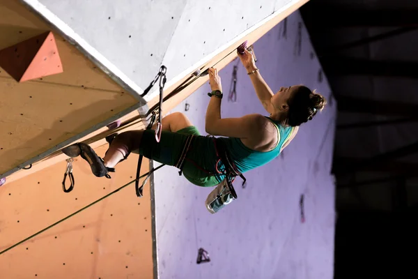 Arrampicante donna sul tetto strapiombante in illuminazione notturna — Foto Stock