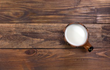 Sert ahşap masa üzerinde geleneksel kırsal Mug içinde süt