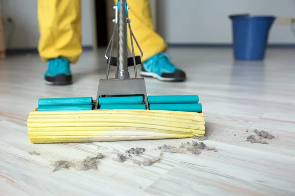 Person washing wooden floor with brush mop — Stock Photo, Image