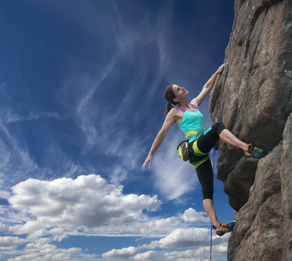 Elegant female climber and cloudy sky — Stock Photo, Image