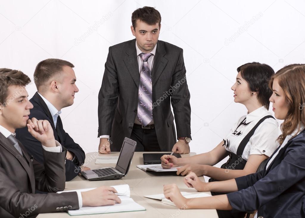 Severe corporate manager is observing his business team