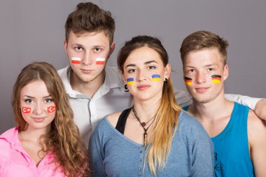 Four teenagers with flags drawn on the faces clipart