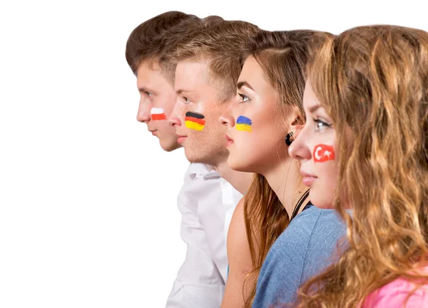 Vista lateral de las caras de cuatro adolescentes con banderas en las caras —  Fotos de Stock