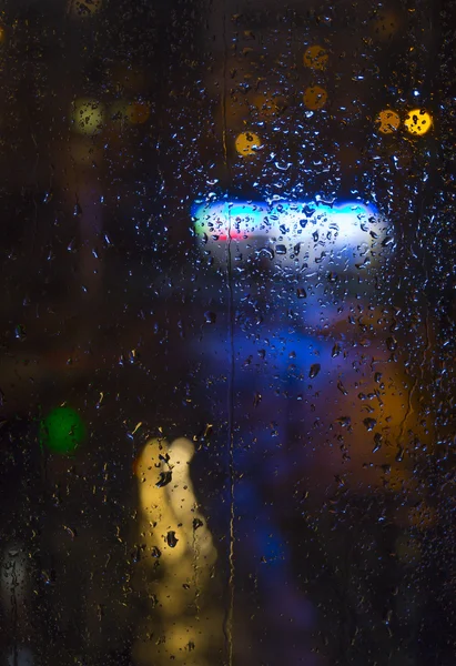 Rain drops on window - night light — Stock Photo, Image