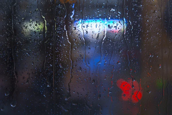 Rain drops on window - night light — Stock Photo, Image