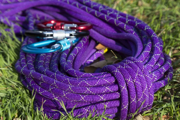 Corda da arrampicata viola su erba verde — Foto Stock