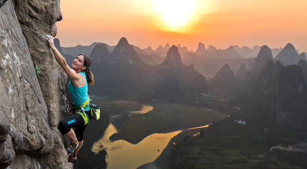Silhouette of female athlete on Chinese mountain sunset