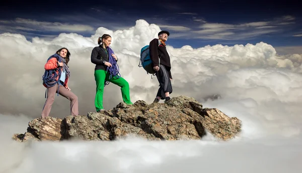 Groupe d'alpinistes séjourne sur la falaise entourée par la mer de nuages — Photo