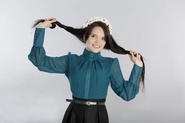 Cute young woman making hair style — Zdjęcie stockowe