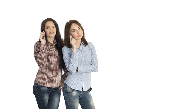 Two beautiful young woman talking on cell phone — 图库照片