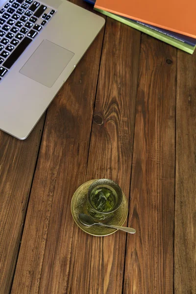 Workplace on wooden desk with tea — Stock Photo, Image