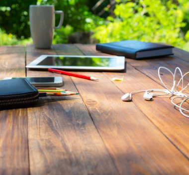 Vertical composition of art items on wooden desk