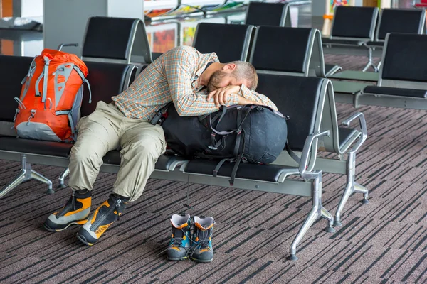 Sleeping man inside transport terminal — Stock Photo, Image