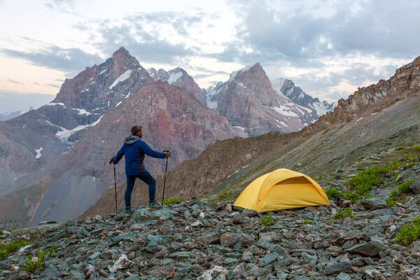 Hiker camping tent and mountain landscape