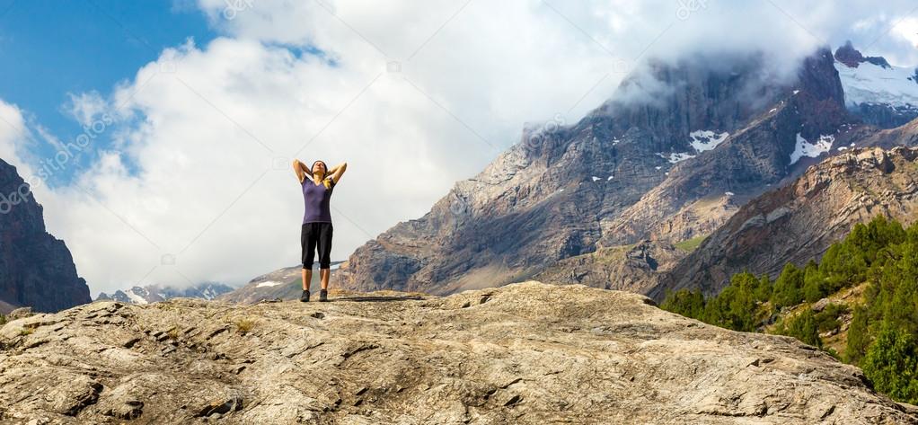 Young Woman Doing Morning Fitness Outdoor in Mountain Landscape