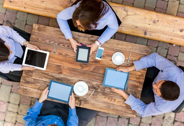 Business people with Digital Devices at cafe Table