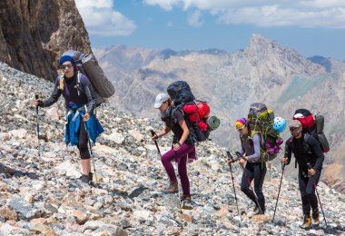 Group of Mountaineer Walking on Deserted Rocky Terrain