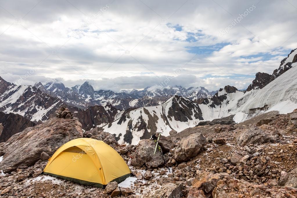 Yellow tent on mountain landscape