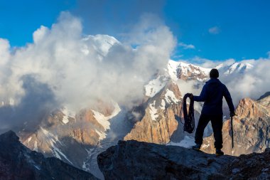 Alpine Climber Arranging Descent with Rope and Ice Axe