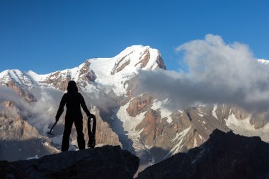 Alpine Climber Arranging Descent with Rope and Ice Axe clipart