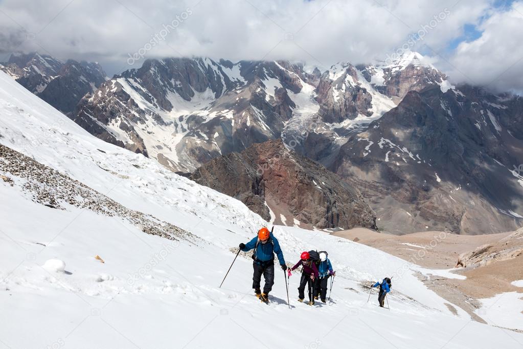 Group of Hikers Walking on Snow and Ice Terrain