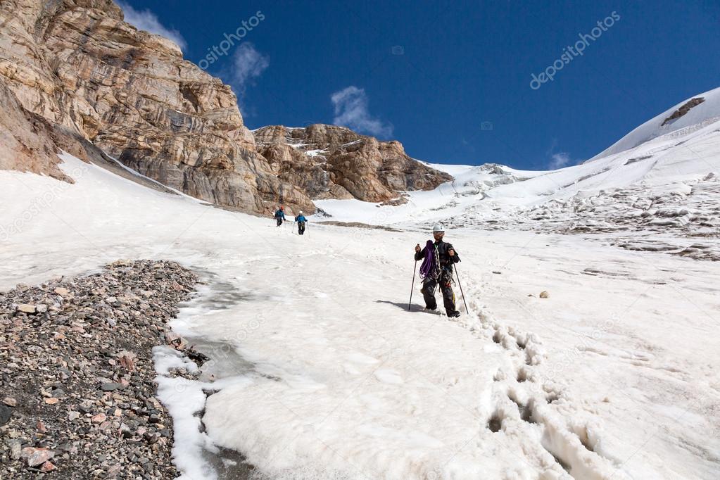 Hikers Walking Down on Snowfield