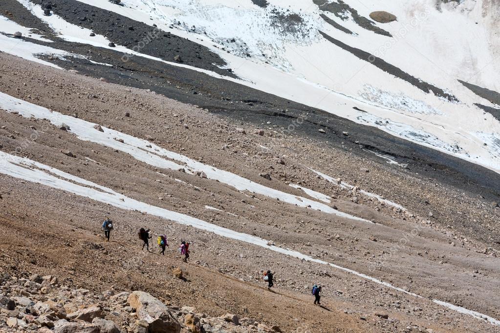 Group of Hikers Walking on Deserted Rocky Terrain
