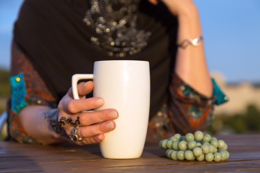 Arabian Female Hand with Coffee Mug and Rosary clipart