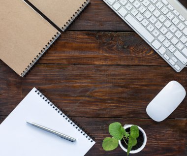 Dark Brown Wooden Desk with Stationery and Electronics clipart