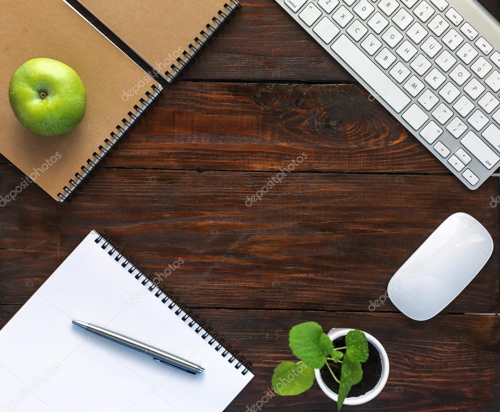 Dark Brown Wooden Desk with Stationery and Electronics