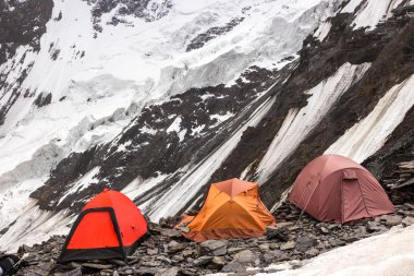 Three Alpine Tents Settled on Edge of Abyss