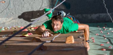 Mature Athlete Hanging on Hand and Looking Up