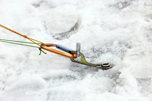 Ice Piton Screwed into Ice with Belaying Ropes and Carabiner — 스톡 사진