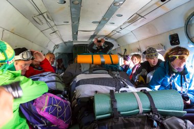Passengers Inside Cargo Helicopter with Many Backpacks